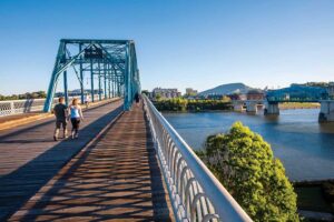 Visitors enjoy the outdoors in the warm spring weather while spending time on the Walnut Street Bridge which connects the Northshore neighborhood to downtown Chattanooga, Tennessee.