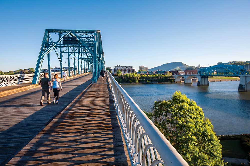 Visitors enjoy the outdoors in the warm spring weather while spending time on the Walnut Street Bridge which connects the Northshore neighborhood to downtown Chattanooga, Tennessee.