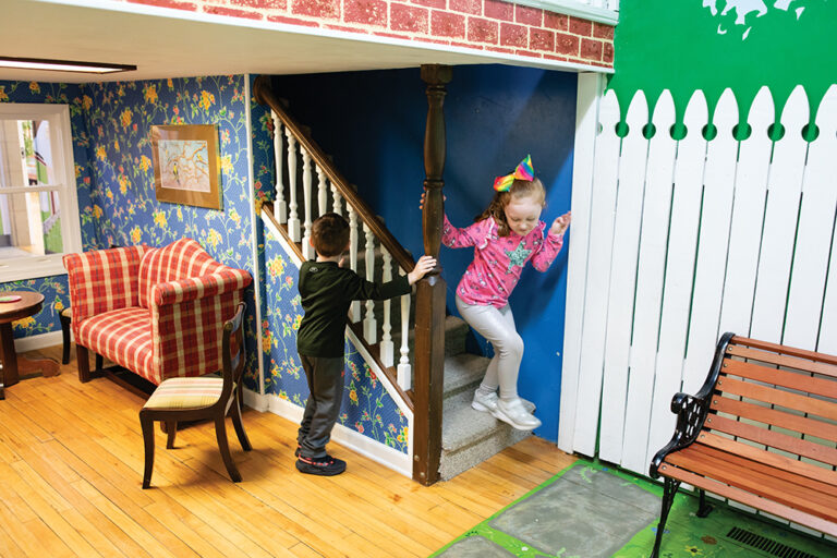 Kimber Jones, 6, plays in a child-sized doll house with Jaxton Tennant, 6, at the Oak Ridge Children's Museum in Oak Ridge, Tennessee.