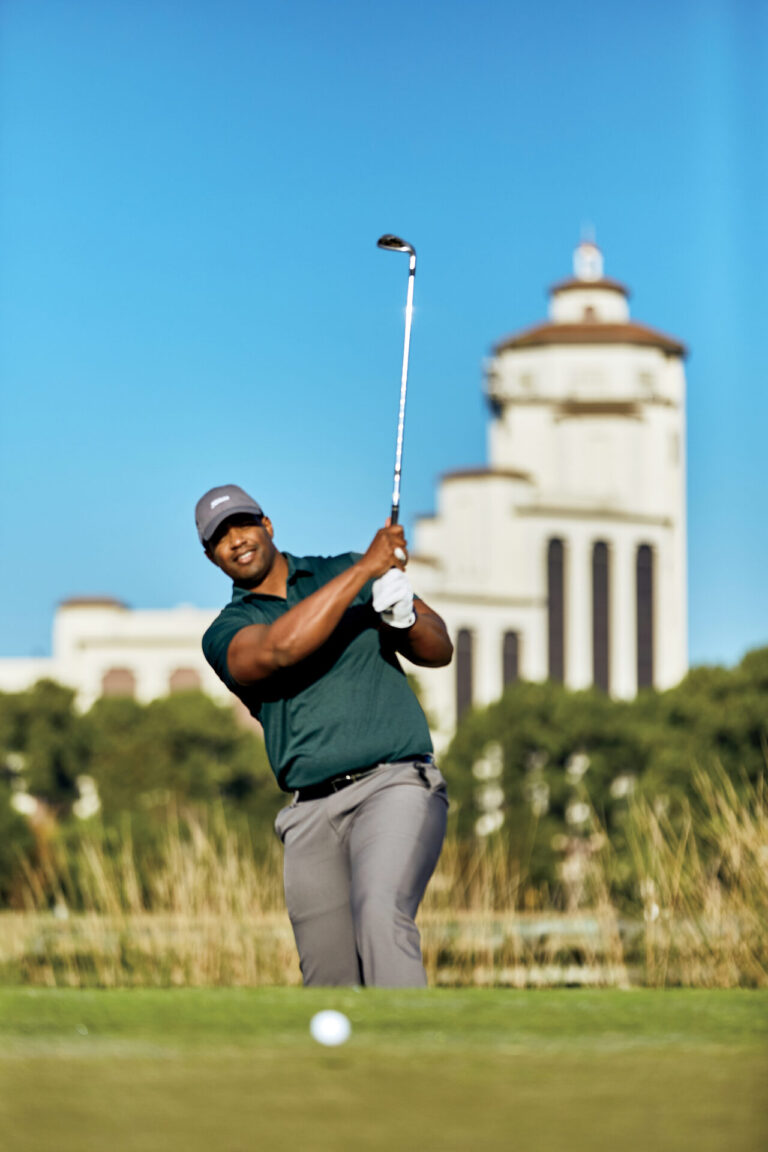 A man play golf at Contraband Bayou Golf Club.