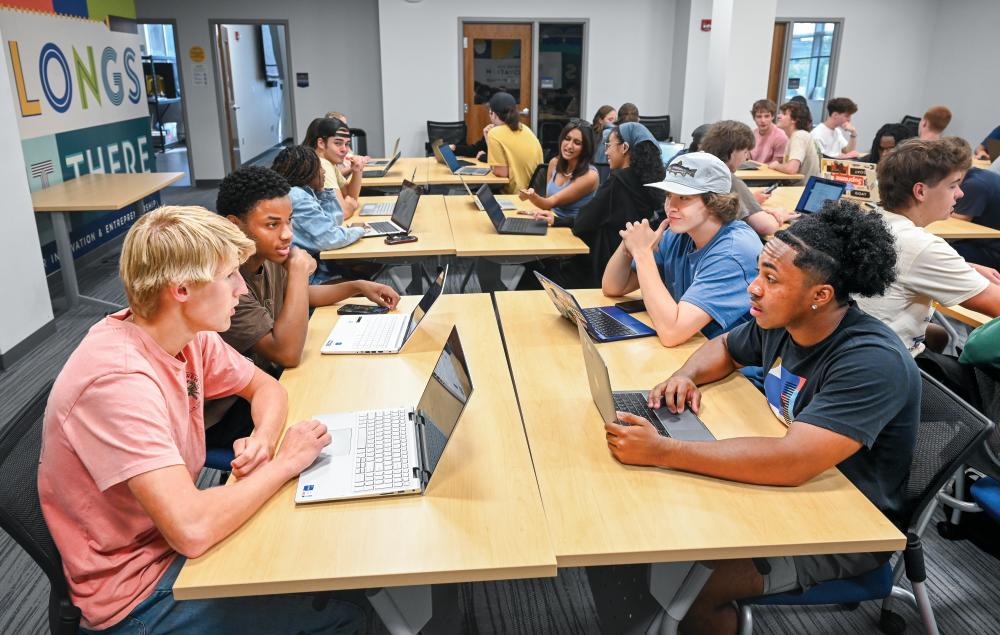 A group of students work together in Entrepreneurship: The Mindset and Skillset class.