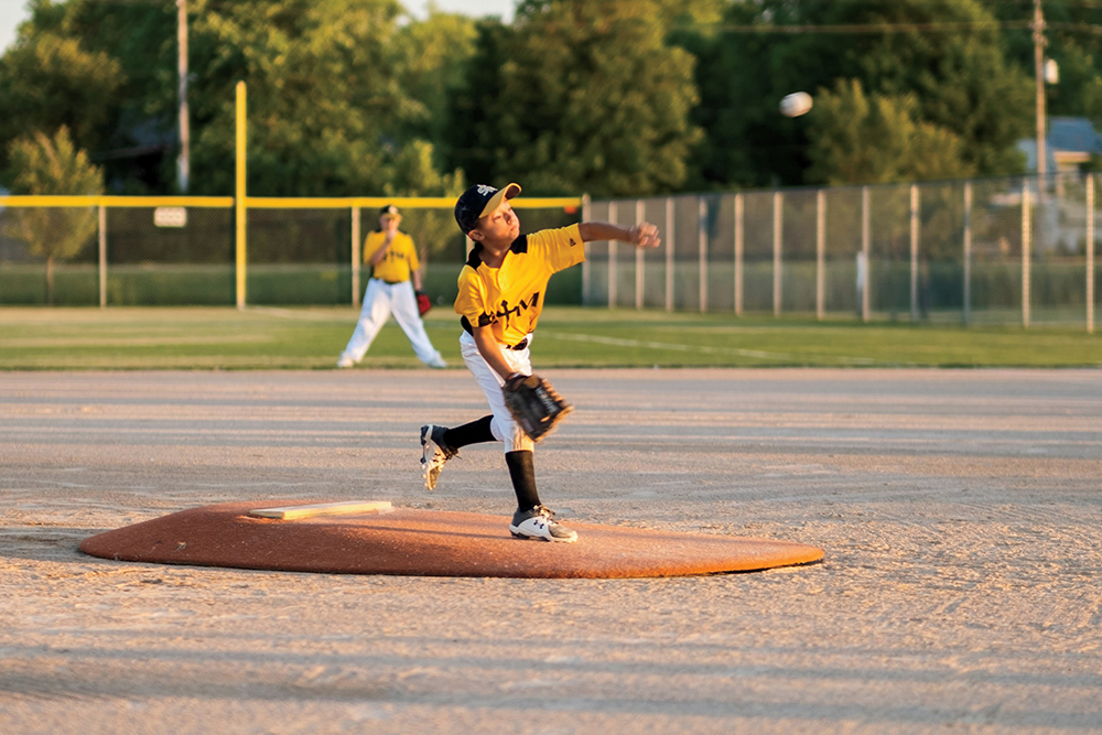 A young boy pitches during a baseball game at Council Bluffs Recreation Complex.