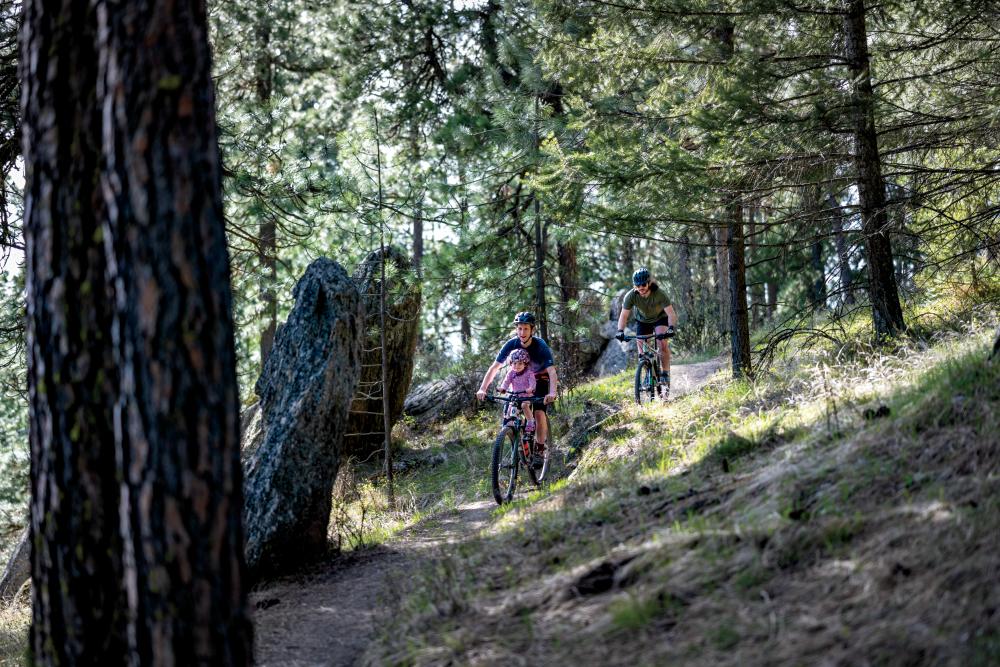 Colin Priebe, his child Alex, and Dominic MacIsaac bike on the Penstemon Path in Moscow, Idaho ©Journal Communications/Chiana McInelly