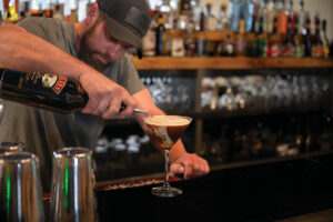 A bartender mixes a drink at The Chopping Block in downtown Pottsville, PA. It's among the must-try restaurants in Schuylkill County.