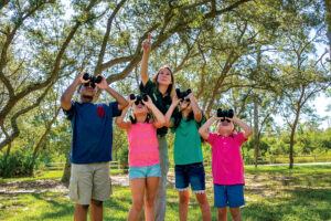 Childen use binoculars to spot birds at Gulf State Park.