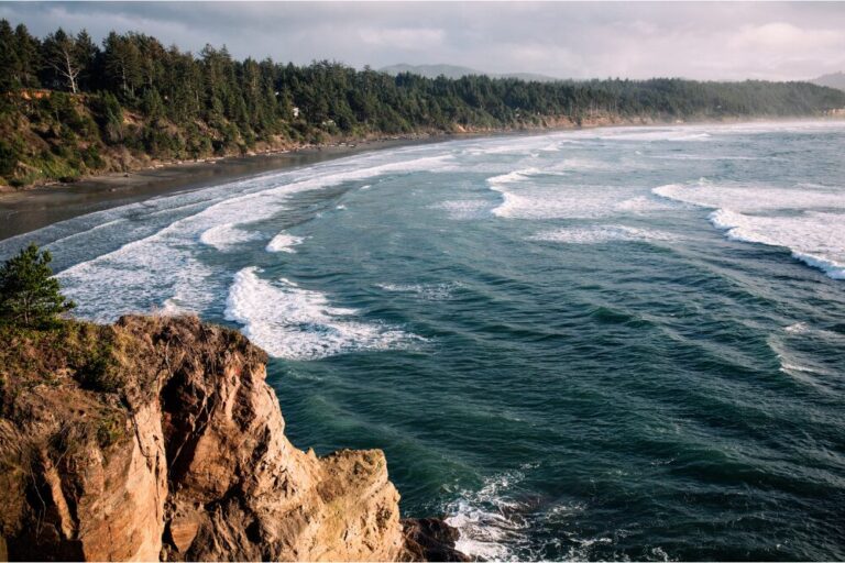 Aerial drone footage from the coast of the Pacific Northwest, featuring Oregons beautiful rugged terrain and blue ocean waves. Captured at Otter Rock near Lincoln City, Oregon, USA.