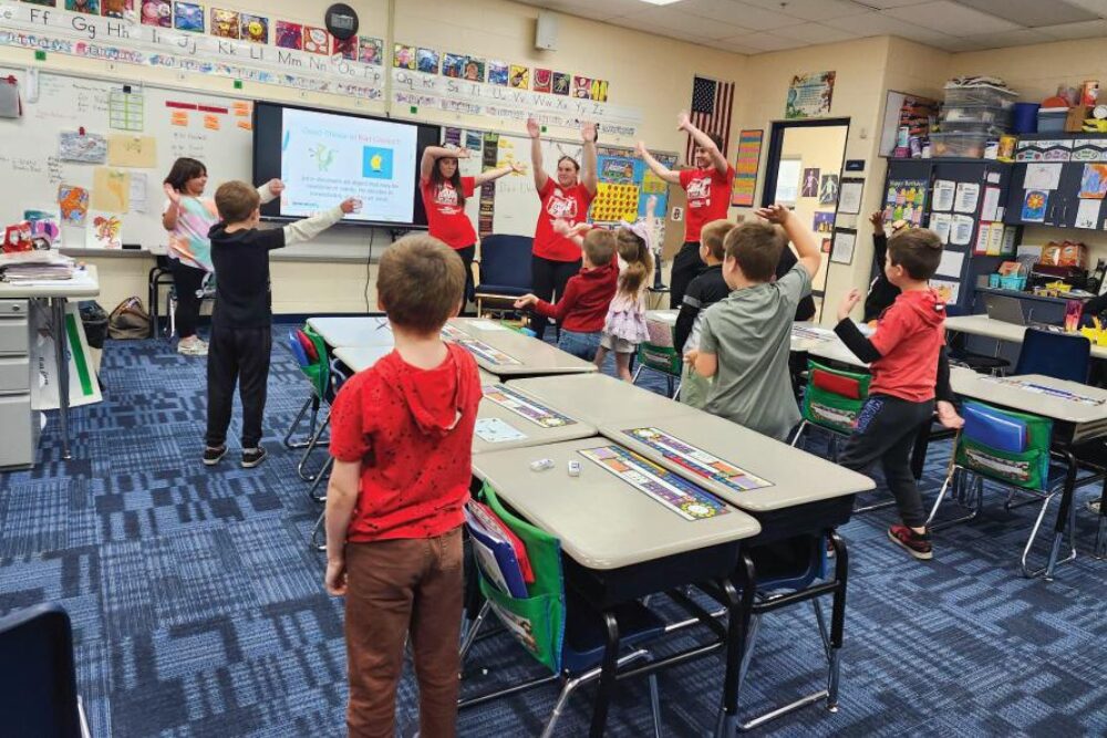 YLP students leading activities in middle school classroom.
