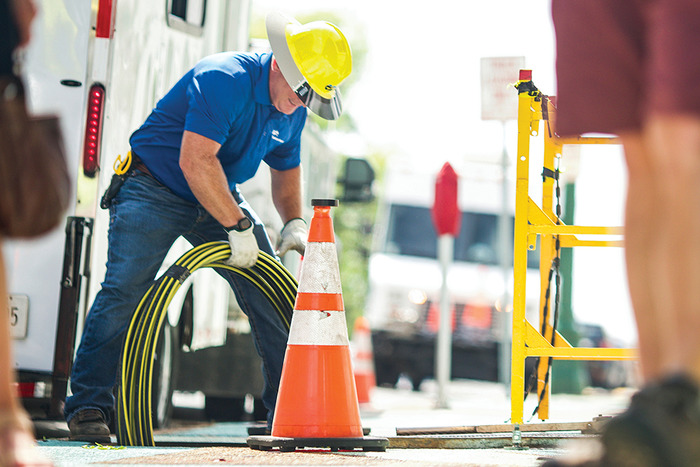 An EPB employees installs fiber cables.