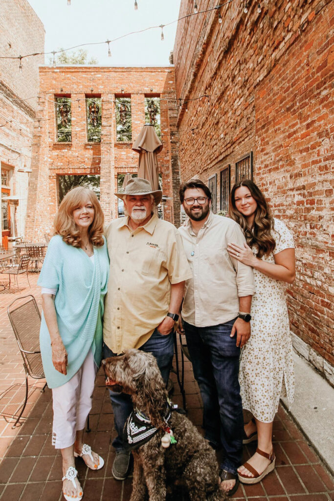 Barbara and Ralph Terry, left, and Brandt and Julia Archer pose for a photo in the courtyard at Whiskey Alley Saloon.