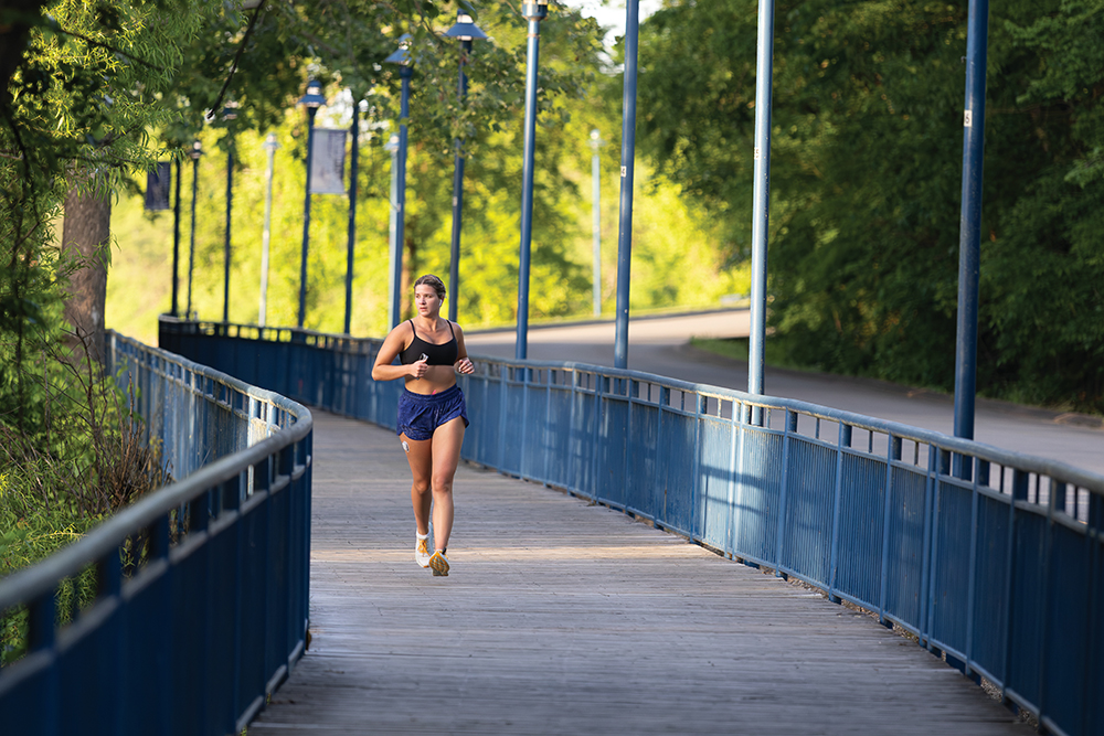 Visitors jog along Tennessee Riverwalk along the Tennessee River near downtown Chattanooga, Tennessee.
