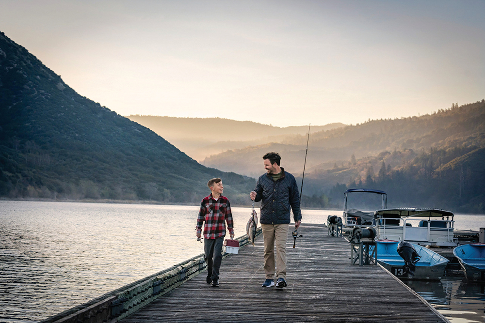 A father and son haul their catch on a dock at Silverwood Lake State Recreation area in Hesperia, CA. It's one of many amenities available to residents of the Victor Valley community.