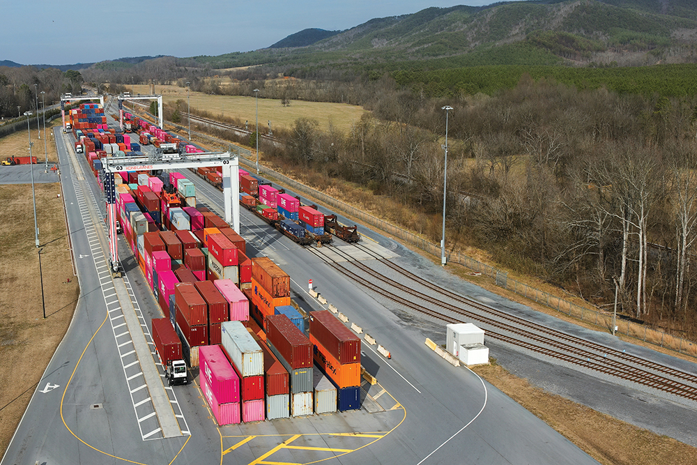 Brightly colored shipping containers are stacked beside a rail line at Appalachian Regional Port in Murray County, GA.
