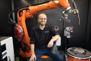 CEO Nick Johnson sits in the portable Monarc WAAM Platform at One-Off Robotics, which specializes in robotic metal additive manufacturing at the INCubator in Chattanooga, Tennessee.