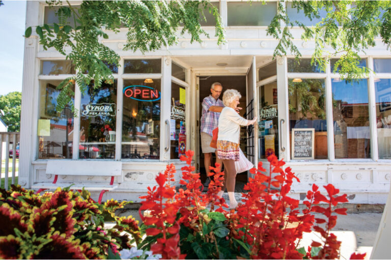 A couple walks out of the Sykora Bakery in Czech Village in Cedar Rapids, Iowa.