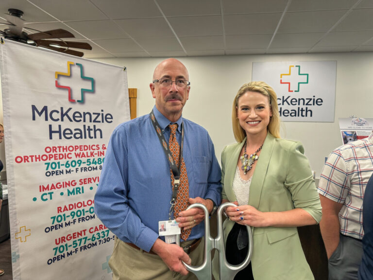 Pete Edis and Anna from the Williston Chamber at McKenzie Health ribbon cutting