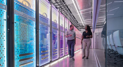 A man and woman walk inside the quantum network control room at EPB.