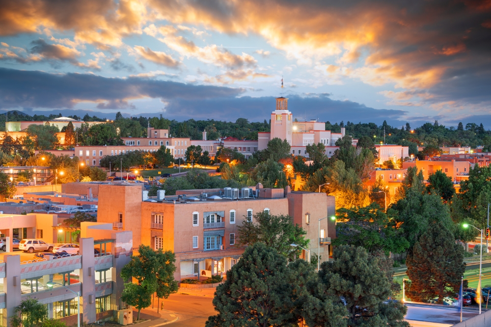 The downtown skyline of Santa Fe, New Mexico at dusk.