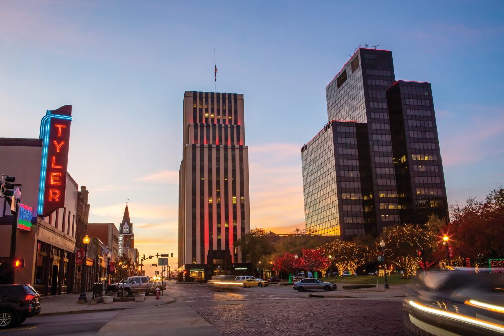 A view of the downtown cityscape in Tyler, TX at sunset.