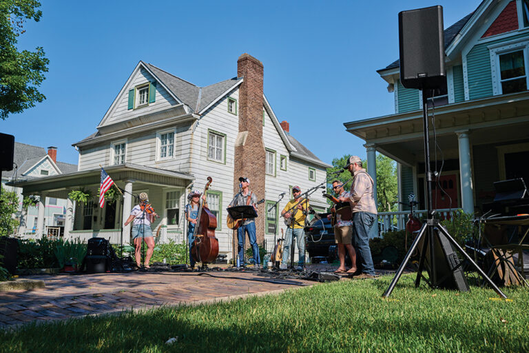 Musicians perform during a yard sale in the popular Moss Avenue historic neighborhood.