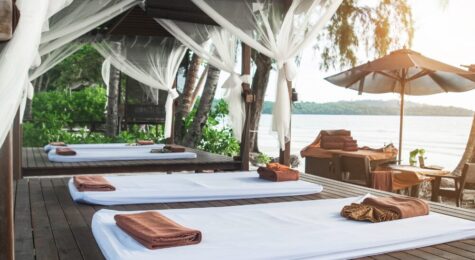 Massage mats laid out with a beach view at a spa. Whole body wellness is a booming business with options ranging from hot springs and forest bathing to wellness retreats.