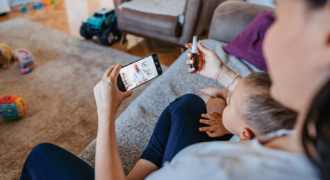 Woman Having A Doctor's Appointment Online With Her Son At Home