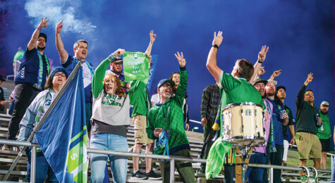 Greenville Triumph soccer fans chant and wave flags.