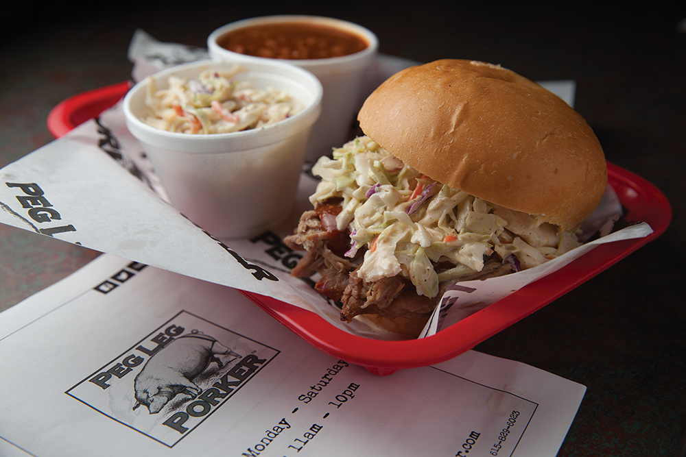 Pulled pork sandwich with slaw and sides at Peg Leg Porker in downtown Nashville, TN.