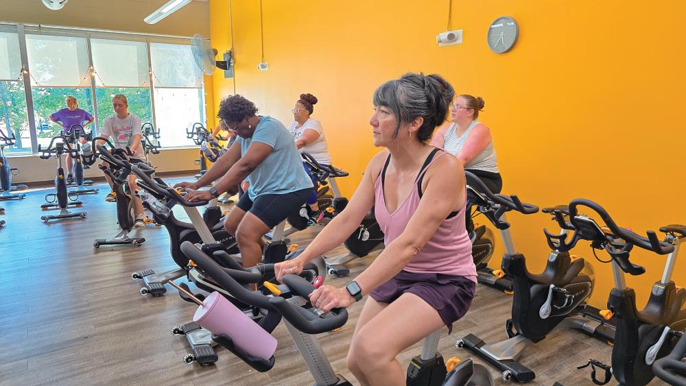 School bookkeeper Kelley Evatt participates in a spin at the Hamilton Family YMCA.
