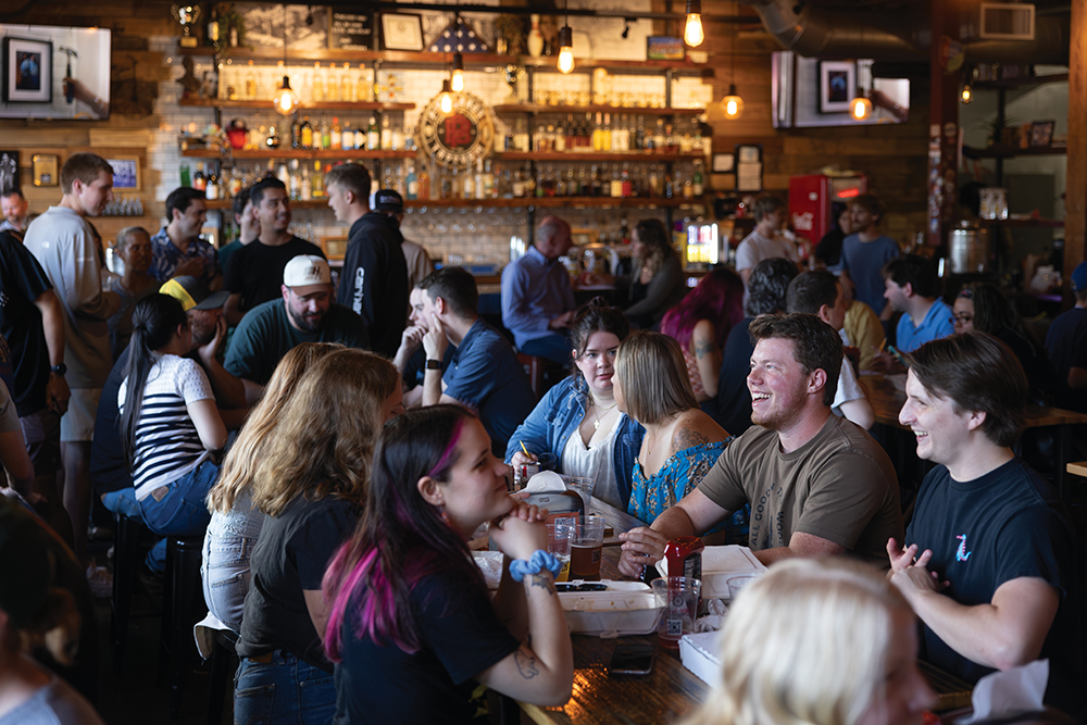 Visitors enjoy beers and food at Pour Bros. Craft Taproom in Peoria Heights, Illinois.