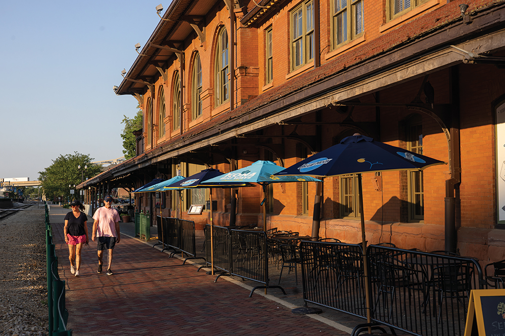 Visitors walk past the Blue Duck at River Station in downtown Peoria, Illinois.