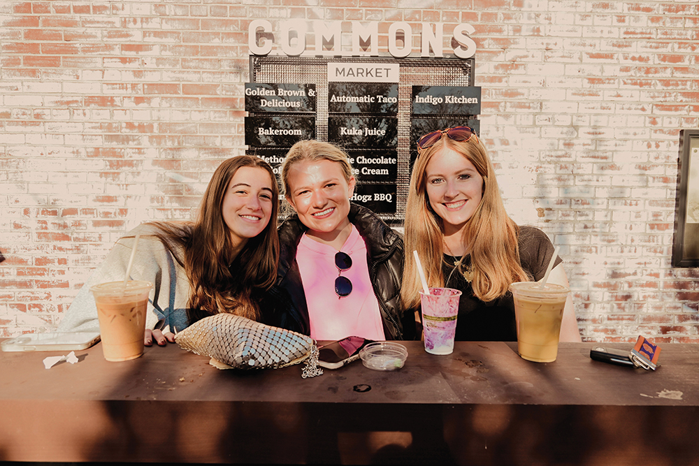 Three women enjoy coffee at The Commons in Greenville, SC.