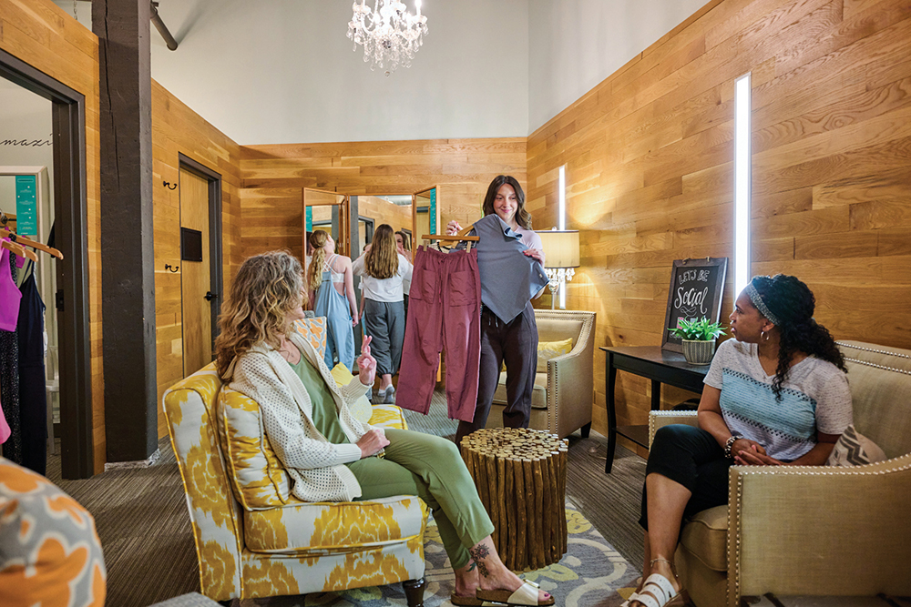 Women discuss their apparel selections in the fitting area of RC Outfitters.