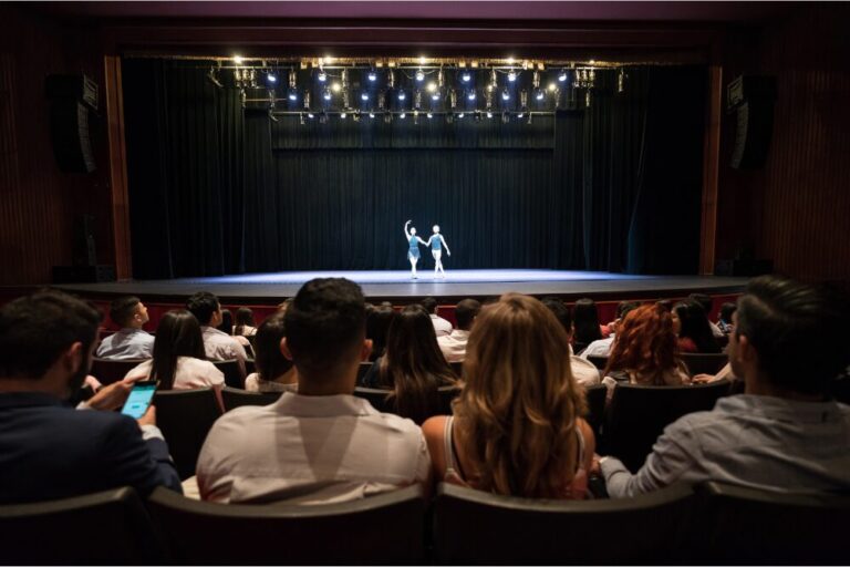People at a theater looking at a dress rehearsal of ballet performing arts stock photo