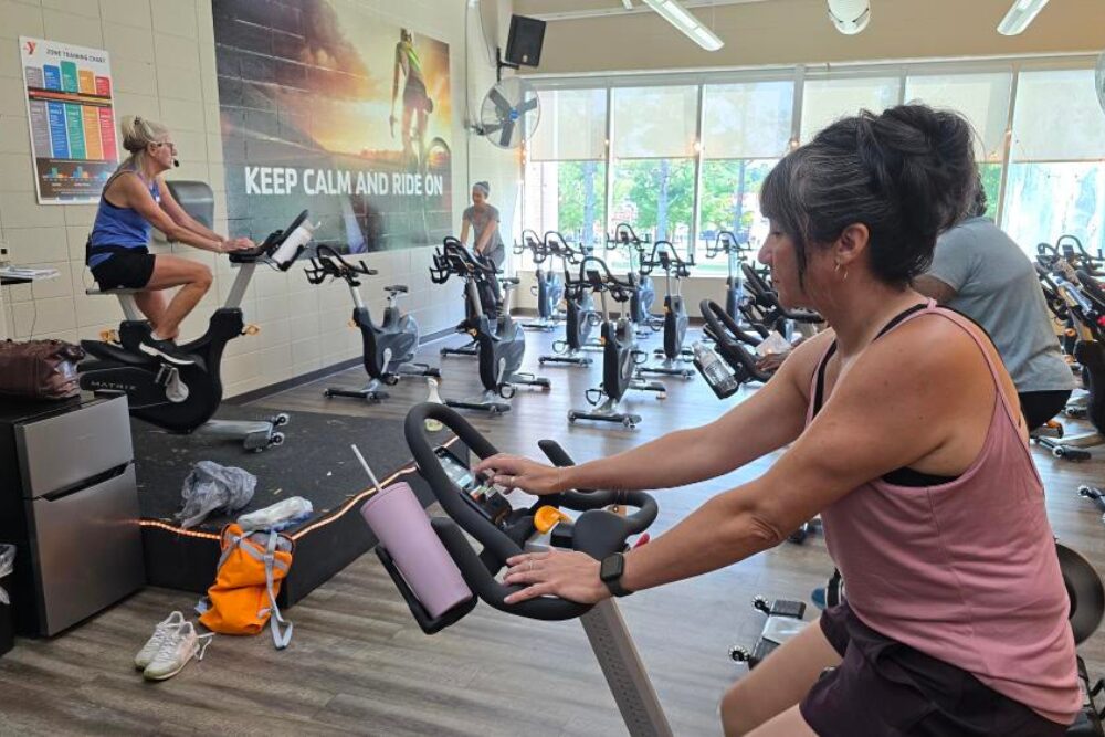 School bookkeeper Kelley Evatt participates in a spin class.