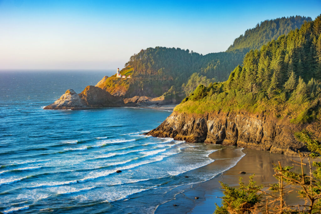 Stock photograph of the Heceta Head Lighthouse on the Oregon coastline, USA on a sunny evening.