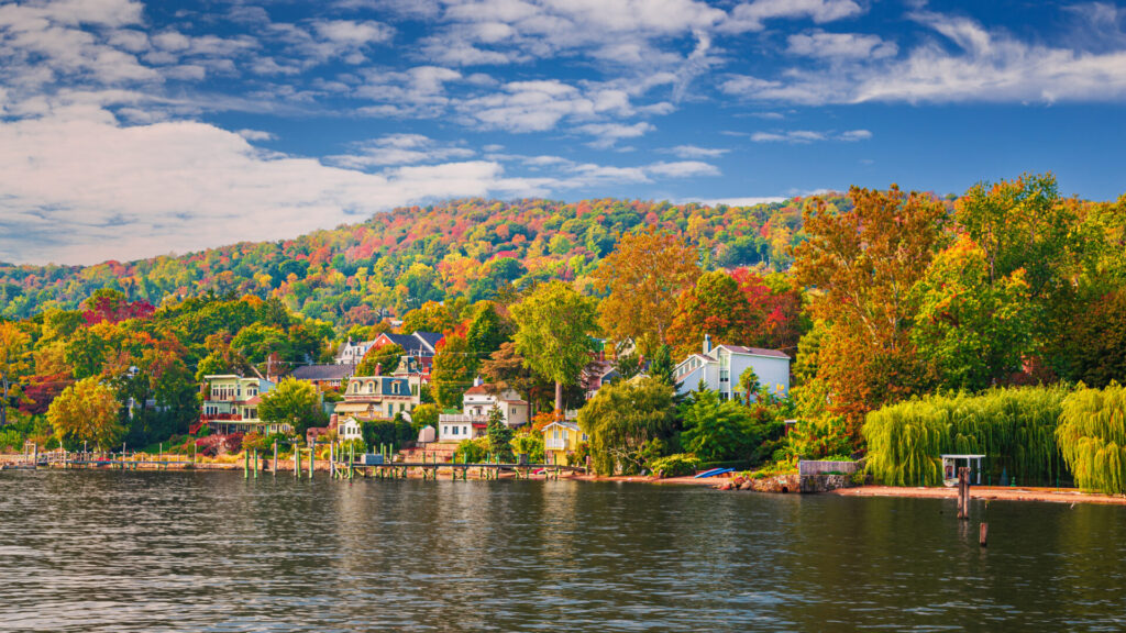 Landscape with Waterfront Houses, Trees in Autumn Colors, Hudson River, Catskill Mountains and Blue Sky in Background, Nyack, Rockland County, Hudson Valley, New York, USA. Canon EOS 6D Full Frame Sensor Camera, Canon EF 24-105mm F/4L IS lens. Panoramic image with 16:9 Aspect Ratio.Landscape with Waterfront Houses, Trees in Autumn Colors, Hudson River, Catskill Mountains and Blue Sky in Background, Nyack, Rockland County, Hudson Valley, New York, USA. Canon EOS 6D Full Frame Sensor Camera, Canon EF 24-105mm F/4L IS lens. Panoramic image with 16:9 Aspect Ratio.
