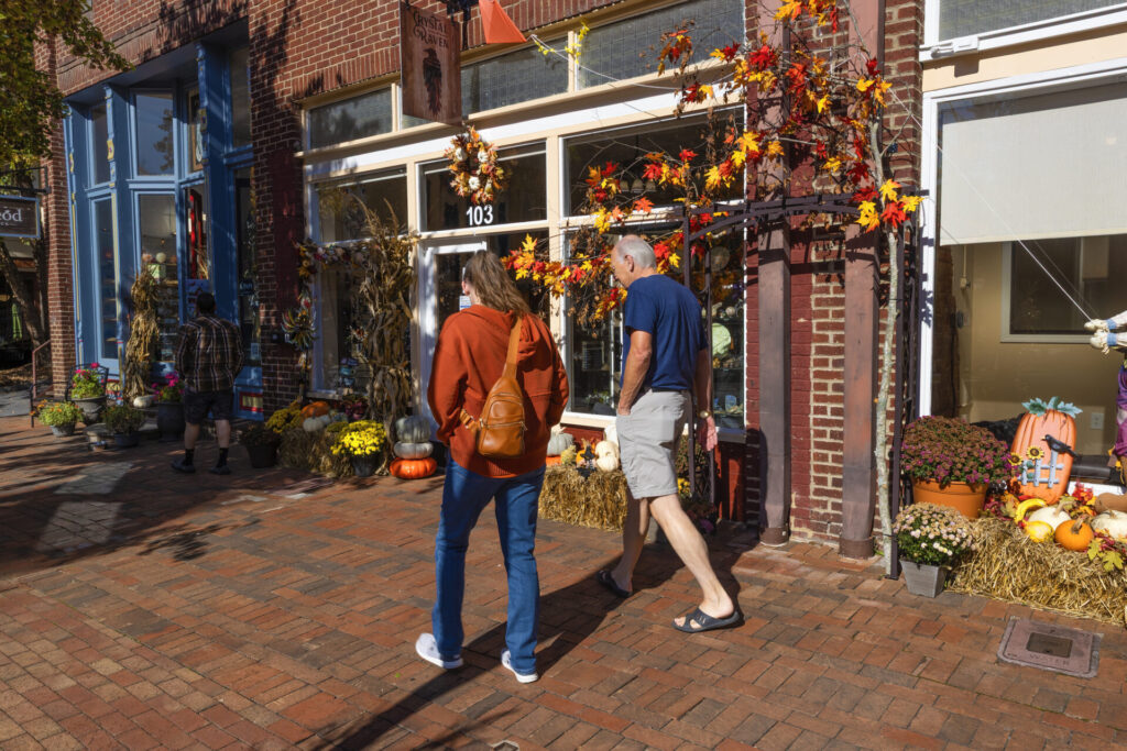 Jonesborough, Tennessee, USA - October 25, 2024: Tourist window shopping in historical downtown district.
