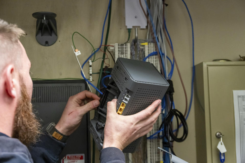 A Cumberland Connect fiber technician installs internet equipment at a local Tennessee business.