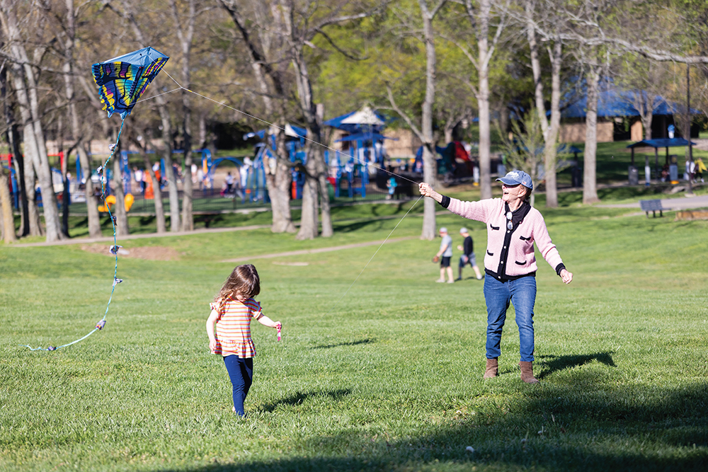 Families fly kites in open fields at Granny White Park in Brentwood, TN.