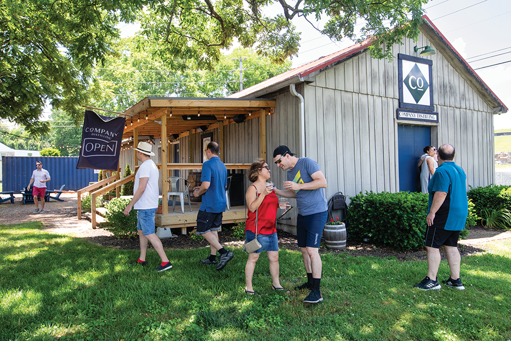 People walk on the grounds at Company Distilling in Thompson's Station, TN.
