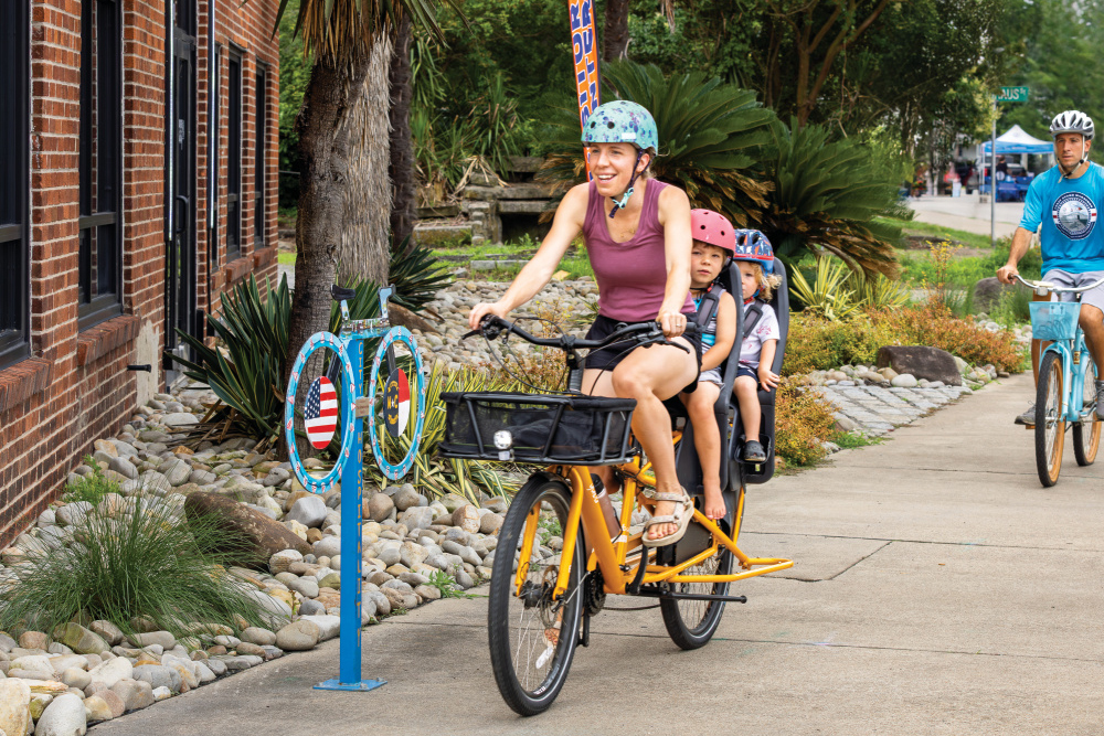 A group of bikers pass the WaterWorks building in Elizabeth City, NC