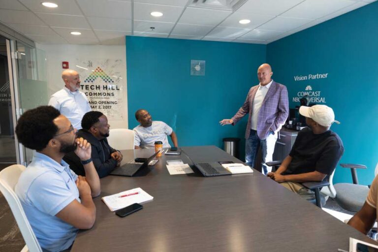 Greater Nashville Technology Council President and CEO Mark Blaze, standing at right, visits with Dr. Drake Dudley, seated left, Rod McDaniel, Dr. Corey Batson and E.J. Reed, seated right, in the council’s office in Nashville.