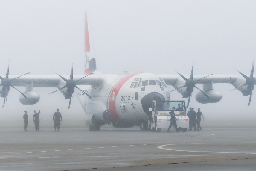 An HC-130J aircraft is inspected by members of Coast Guard Air Station Elizabeth City, North Carolina