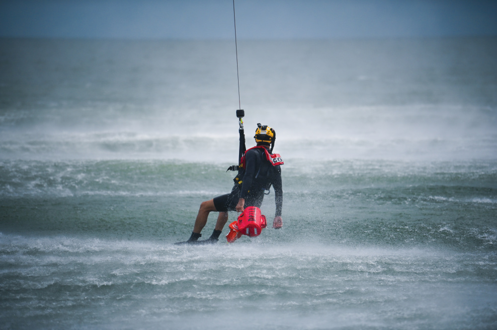 An Aviation Survival Technician from Coast Guard Air Station Elizabeth City retrieves a training buoy during hoisting training with Coast Guard Station Milford Haven in the Chesapeake Bay