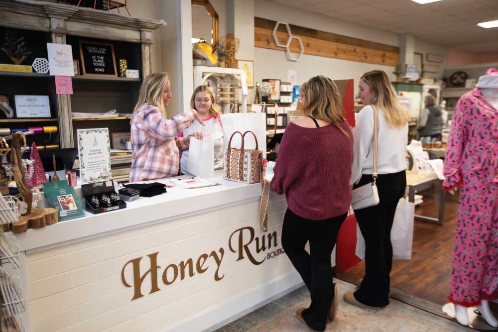 Owner Yvonne Pierson, left, helps customers with their purchases at her Honey Run Boutique in White House.