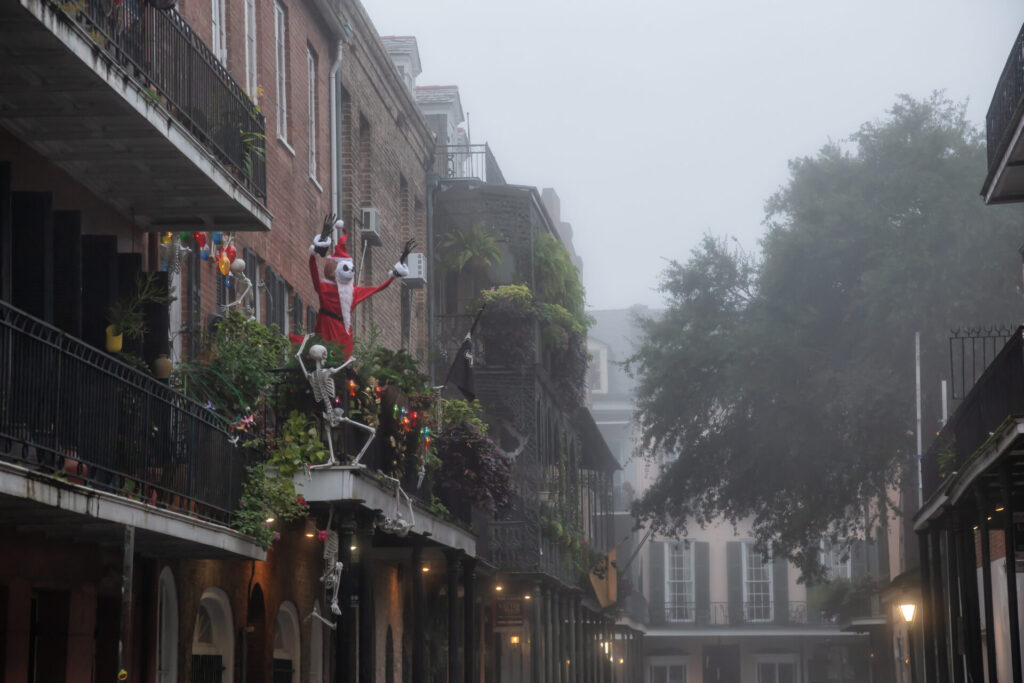 New Orleans, Louisiana, United States - November 7, 2018: Urban Streets with Halloween Decorations on the balcony in the Downtown City during foggy morning.