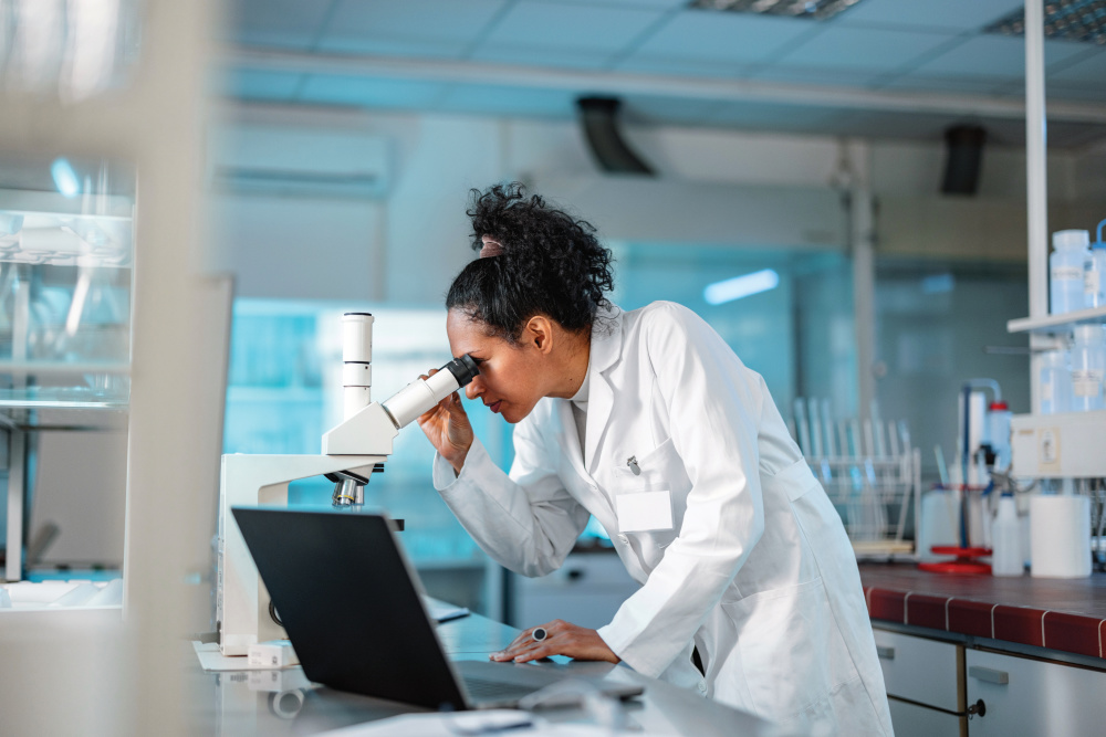 Female Scientist Looking Under Microscope
