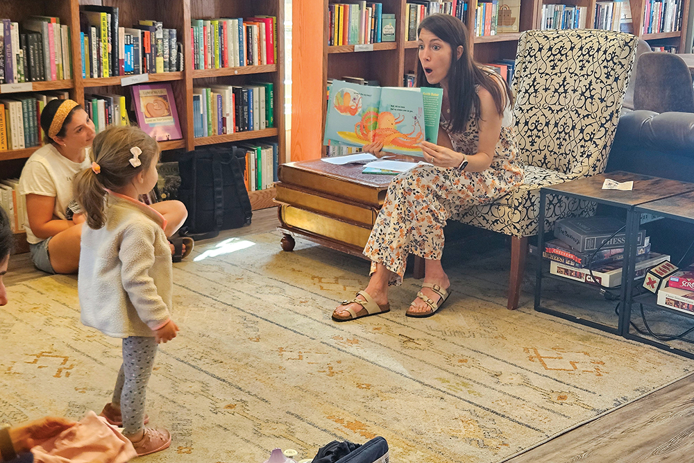 A woman reads a book to a little girl during story time at The Bookhouse in Winston-Salem, NC.