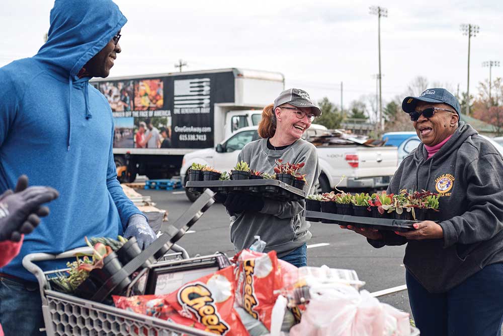 People loading baskets for One Generation Away, an organization that saves literally tons of healthy food from destruction each month and ensures it finds its way to those who need it.