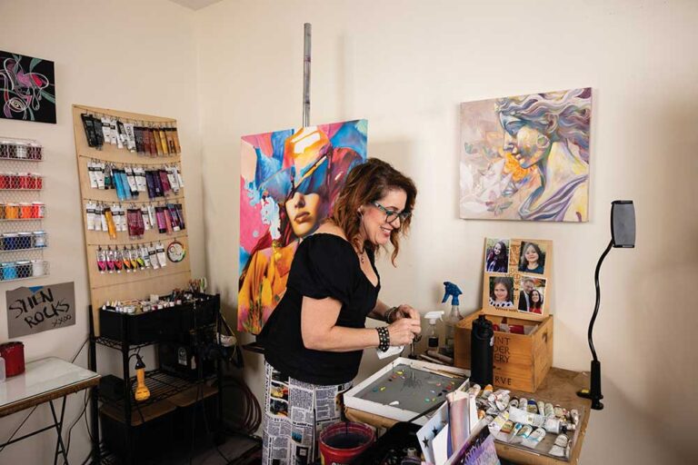 Graffiti artist Shen puts some finishing touches on a painting with oil paint in her home studio in Madison, Tennessee. Her official artist name is ShenShen210.
